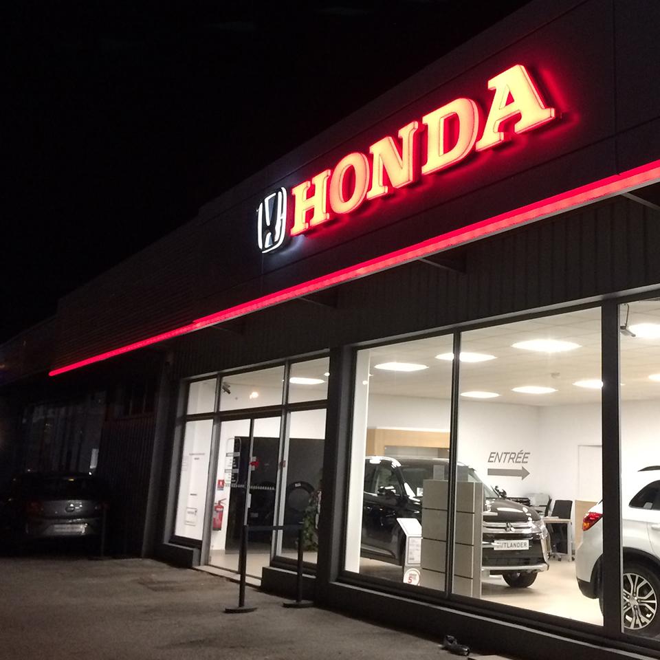 Honda logo lit up at night by Visotec