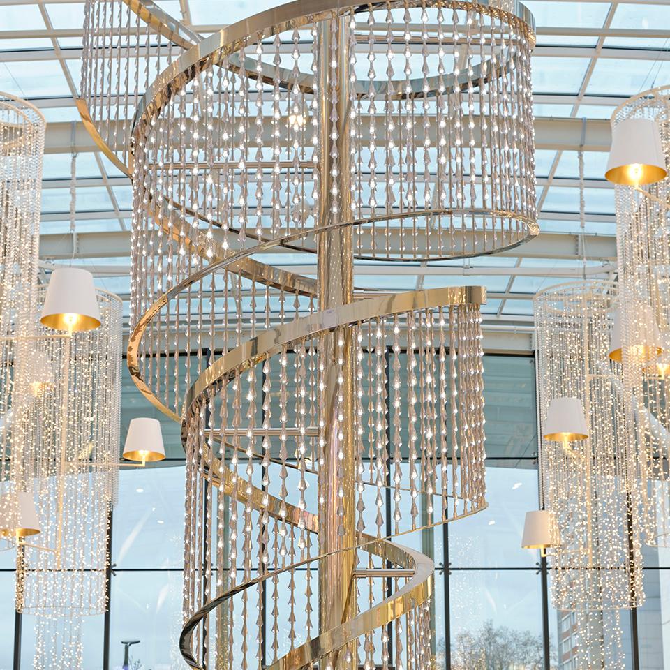 A large, tailor-made lighting arrangement for an atrium public space by Visotec